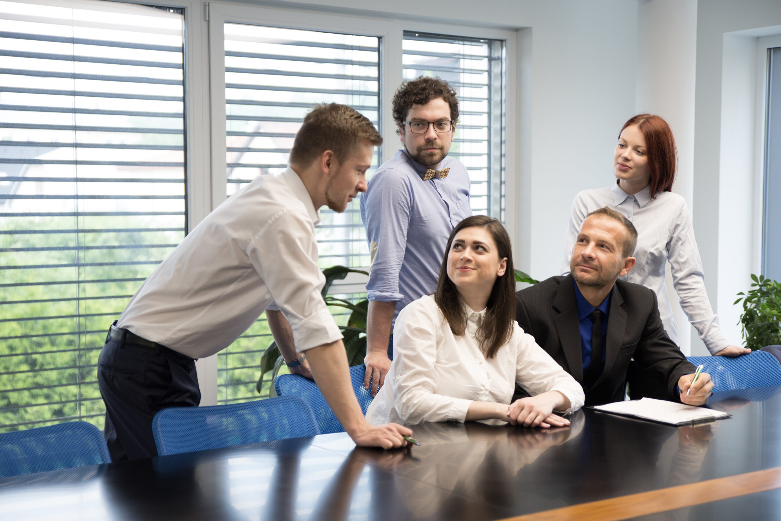 excited coworkers discussing new plant